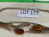 Full view of both necklaces laid out, showing overall styles