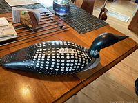 Top view of carved wooden loon decoy on table showing painted details