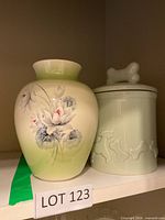 Dog treat jar and vase side by side on shelf