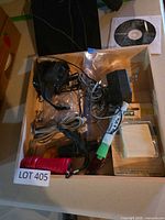 Box of accessories including flashlight, glue, adapter, cables, 3M pads, setup CD
