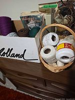 Overview of box with macrame cord, books and basket of crochet cotton