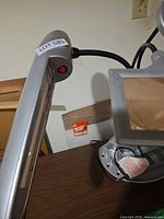 Side view of lamp arm with red power button and wiring