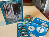 Boxed microscope set with accessories and slide packs