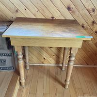 Front view of solid wood table against wall