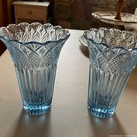 Front view of the two matching blue cut glass vases