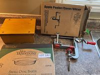 Overall lot showing baker box, apple peeler box and device, wooden shelf