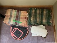 Overview showing three sets: peach placemats, green placemats, black half-round quilted placemats and cream napkins