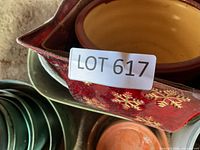 Top view showing red metal snowflake pot, terracotta nested pot, green glazed pots
