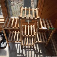 Front view of wooden slatted plant stand
