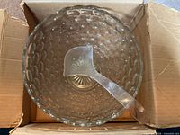 Overhead view of punch bowl with bubble pattern and ladle inside cardboard box