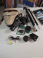 Group shot showing camera, lenses, bag, tripod, film pouch and accessories