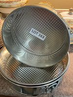 Two springform pans showing textured bases and latch mechanisms