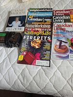 All items laid out on bed: radio, book, five magazines