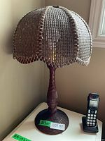 Full view of wicker table lamp on side table