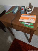 Top view of cabinet with instruction book, accessory boxes and power cord visible