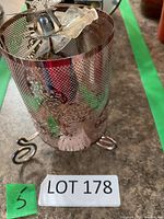 Copper perforated metal tealight holder on tripod feet with dragonfly accent