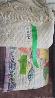 Overall view of throw blanket over quilt with lot tag