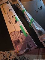 Box showing halogen track light illustration and bundled curtain rods