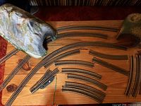 Curved and straight track sections with mountain tunnel and turnout piece on tabletop