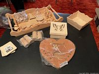 Entire lot of unfinished wood craft items on table