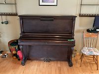 Front view of Bell upright piano showing cabinet and overall condition