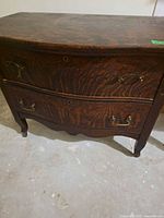 Full view of dresser front showing two drawers, hardware, grain pattern