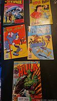 Five comics laid out: Lost in Space, Little Lulu, Tom and Jerry, Road Runner, Hulk