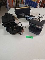 All three cameras with cases on table