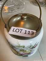Overall view of biscuit jar showing floral design and metal lid