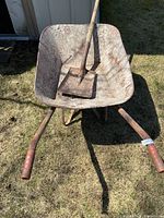 Top view of wheelbarrow interior and shovel resting inside