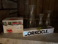Lot overview with boxed Avvinatore rinser, three glass carafes, boxed Corkcicle chiller