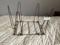 Overall view of wire magazine holder on bed