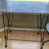 Full view of plant stand showing wood top, legs and lower shelf