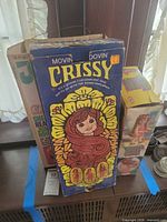 Front of Movin' Groovin' Crissy box with other doll boxes partly visible