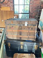 Two stacked steamer trunks showing size and hardware