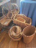 Group of assorted wicker and rattan baskets on floor