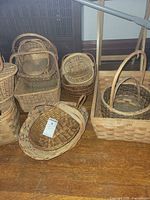 Multiple sizes and styles of wicker, rattan and wood slat baskets on floor