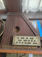 Full view of autoharp showing chord buttons, strings and finish