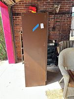 Full left side view of brown metal cabinet
