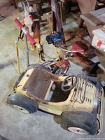 Group view showing ride-on car, rocking horse, tricycle, scooter