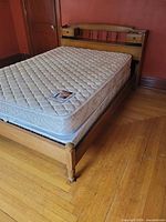 Full view of assembled bed showing headboard with nightstands, mattress, and footboard