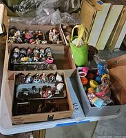 Multiple boxes containing decorated egg ornaments and plastic eggs