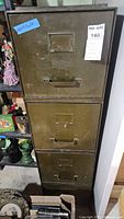 Front view showing four drawers, handles, Art Metal logo, wear