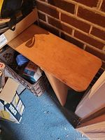 Wooden bench top with light brown finish and angled supports