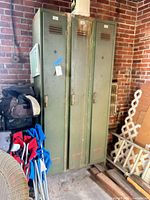 Full view of three-door green steel locker in garage