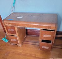 Front and side view of plywood waterfall desk showing drawer banks and missing drawers