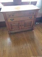 Front view of entire oak sideboard showing drawers, doors and hardware