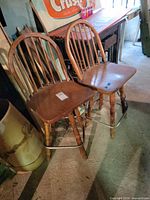 Both oak spindle-back bar stools front view