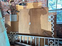 Stacked plywood and lattice with ladder for scale