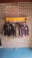 Four jackets hanging on rack showing front views